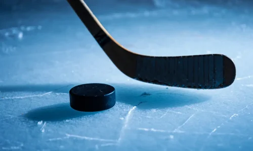 Hockey puck and stick on ice – sports apparel banner for hockey t-shirts and hoodies